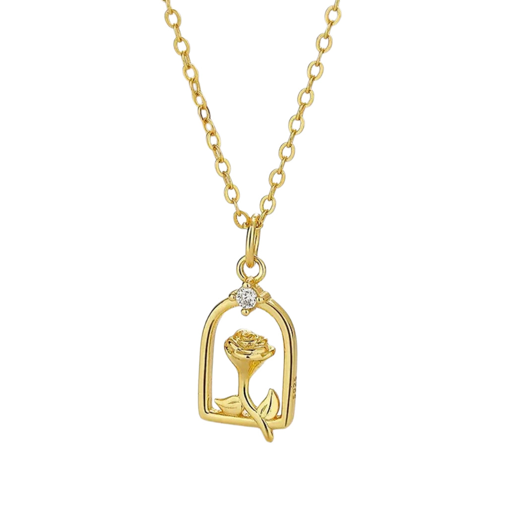 Gold necklace with a rose-shaped pendant, outlined in a archway and featuring small white stones.