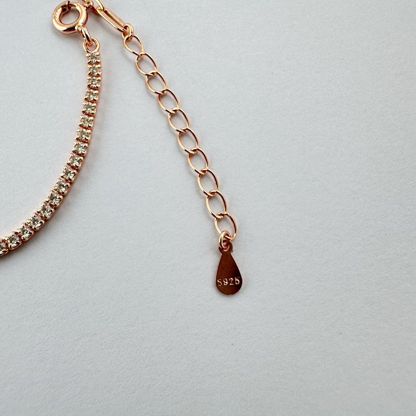 Rose gold bracelet with a diamond tennis chain.
