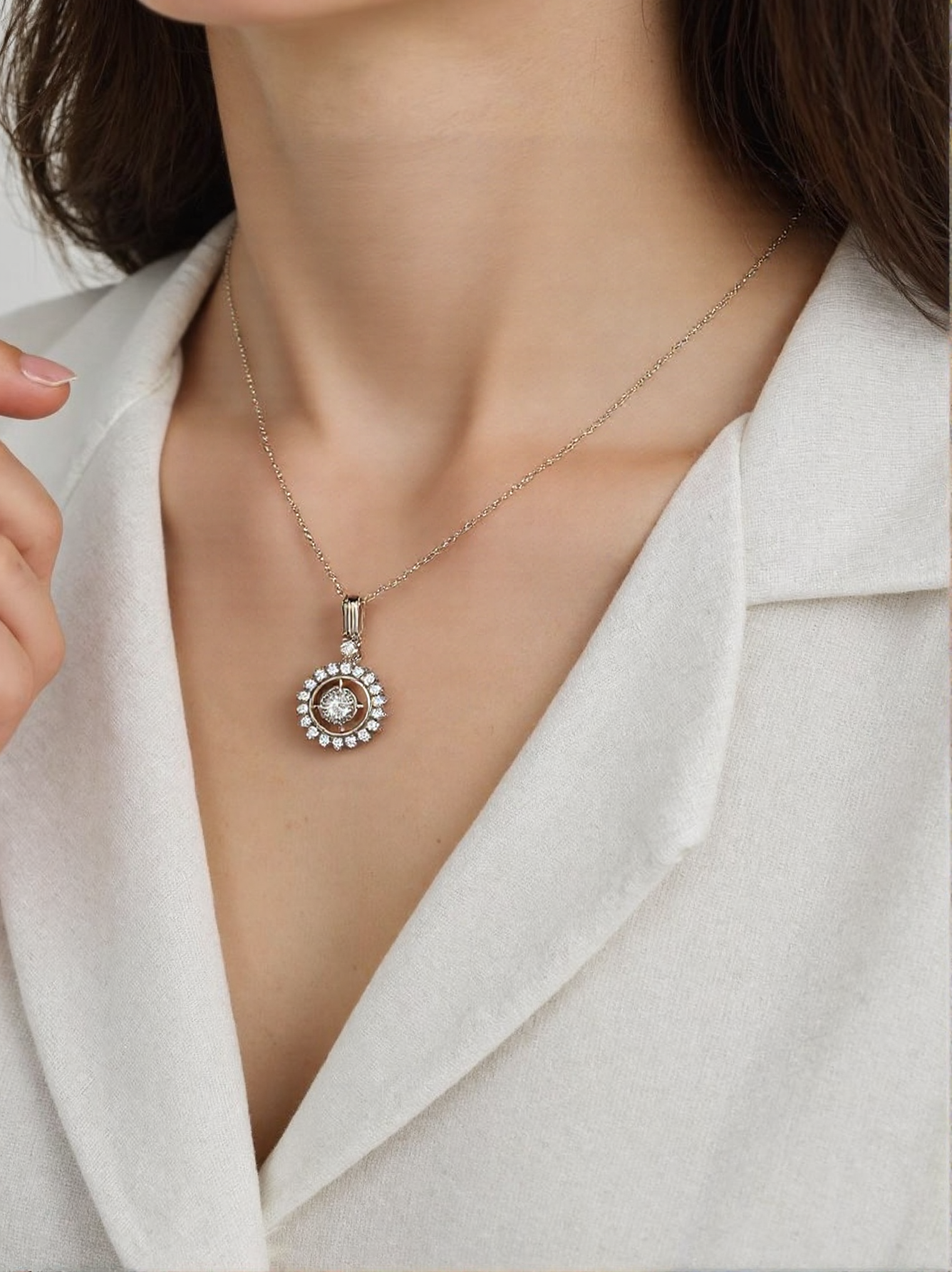Close-up of a woman wearing silver compass charm necklace.