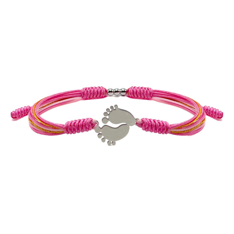 Pink bracelet with a baby feet charm.