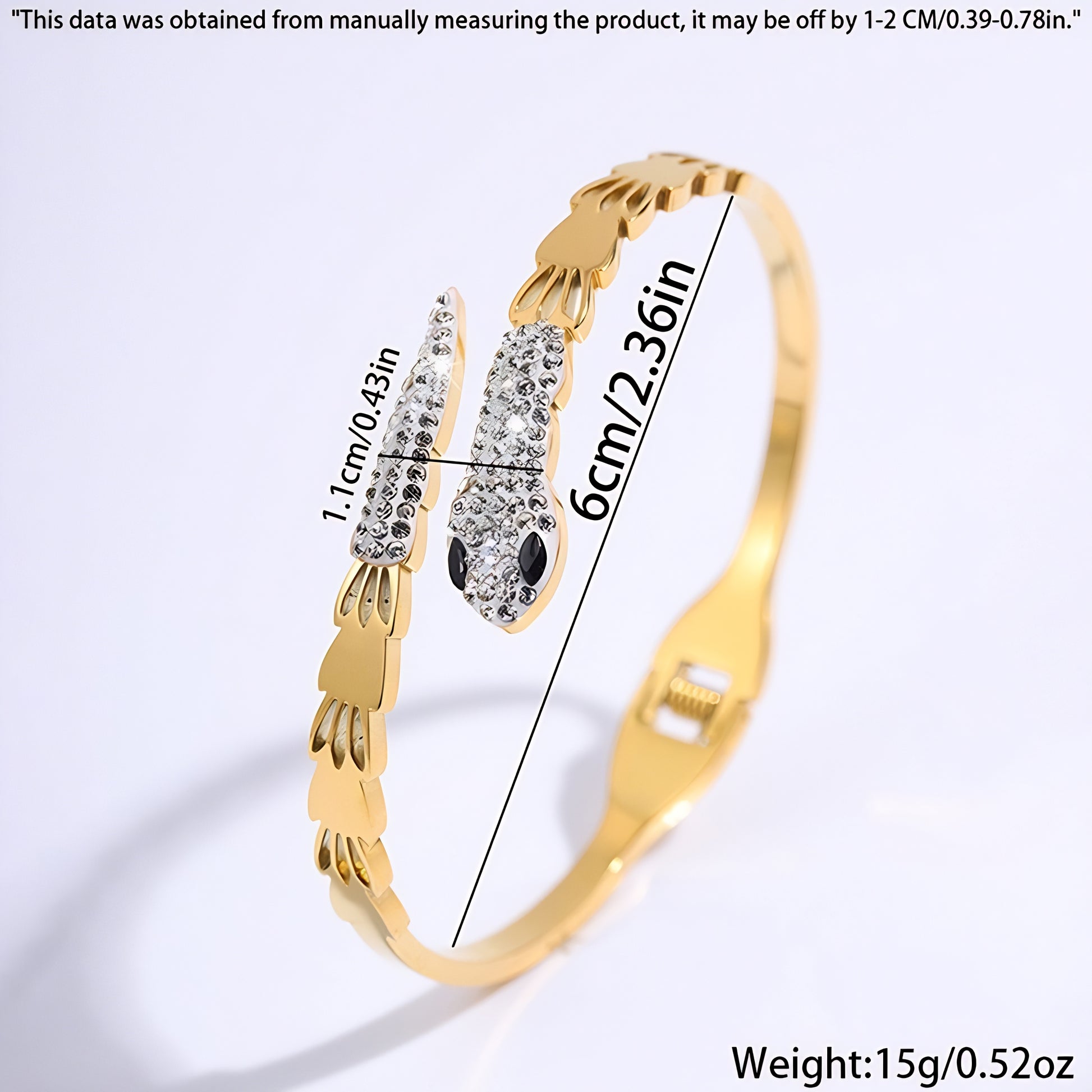 Gold bangle bracelet with a snake design, featuring clear and black crystals.