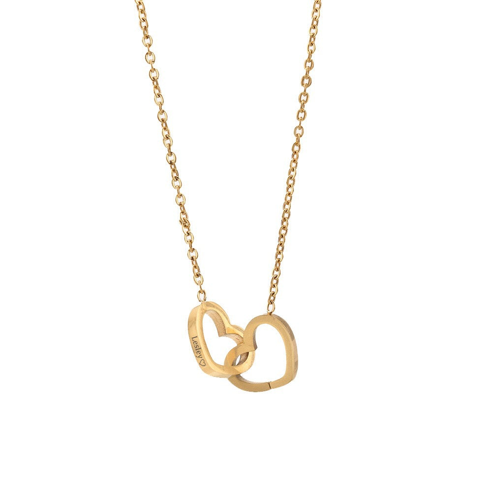 A delicate gold necklace showcasing two intertwined hearts, embodying love and togetherness.