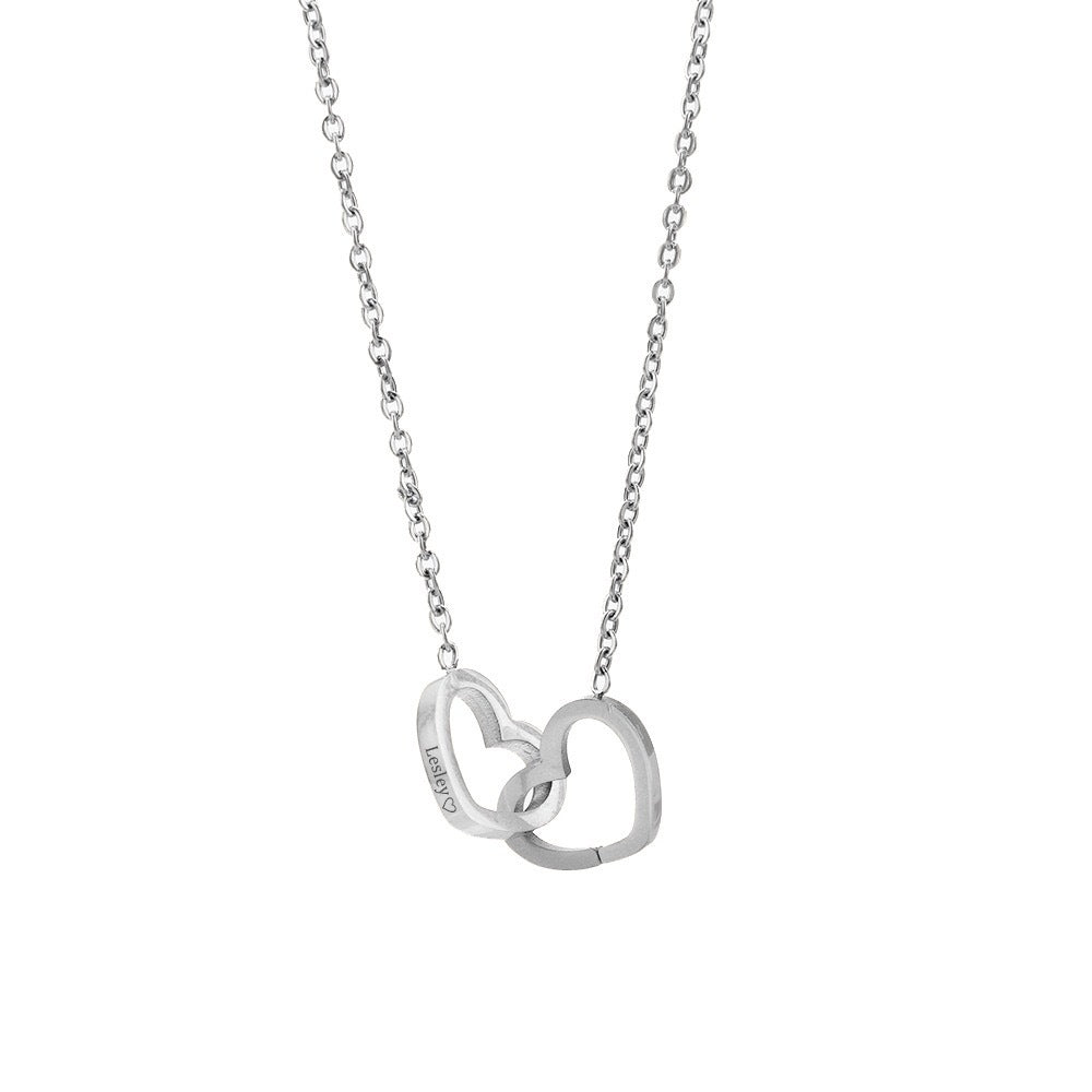 A delicate silver necklace showcasing two intertwined hearts, embodying love and togetherness.