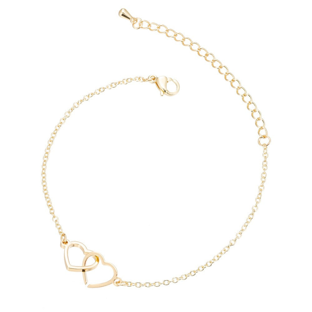 A delicate gold necklace showcasing two intertwined hearts, embodying love and togetherness.