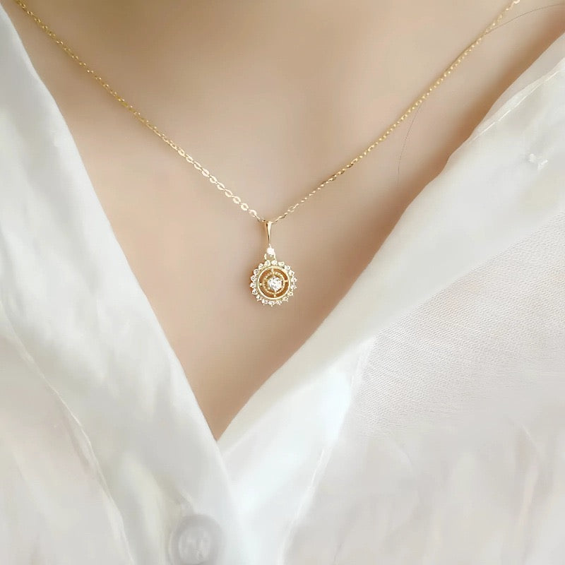 Close-up of a girl wearing a delicate gold necklace with interlocking, diamond-encrusted rectangular shapes.