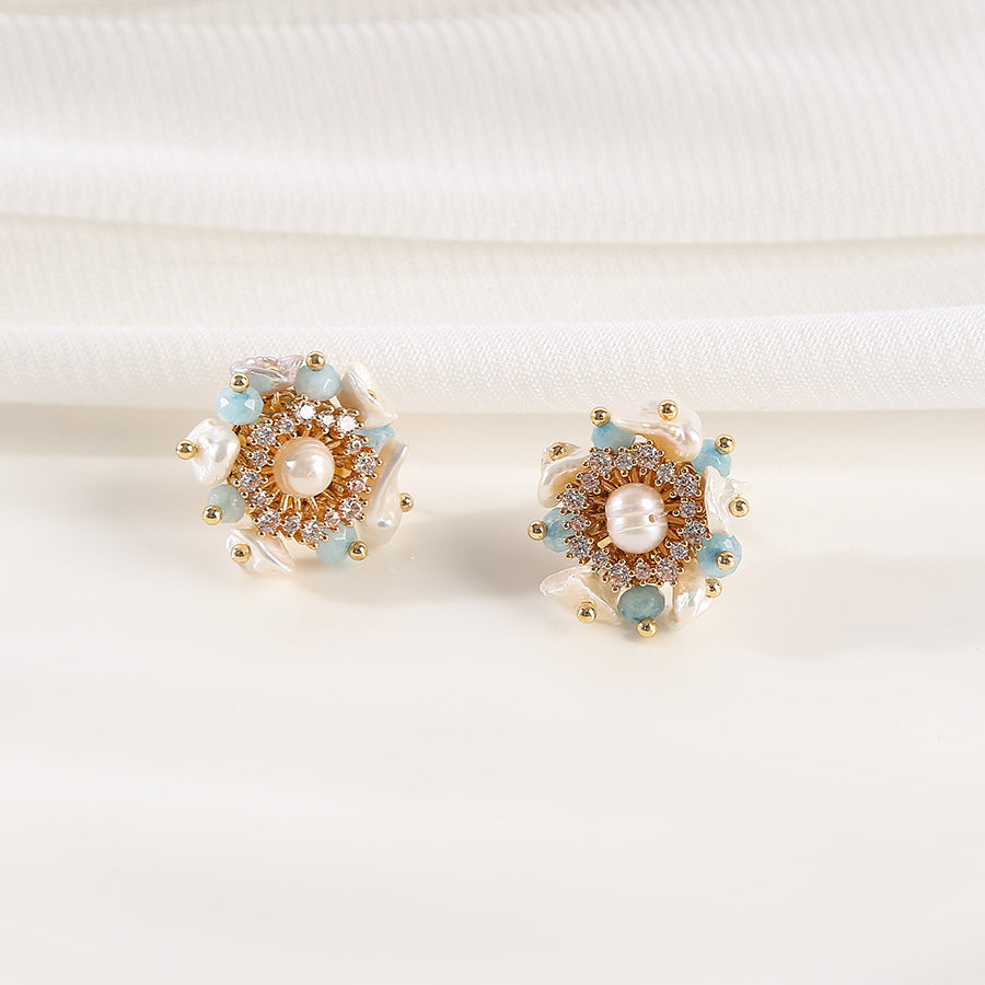 A pair of earrings featuring blue and gold beads, elegantly designed to enhance any outfit.
