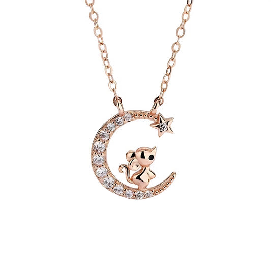 Rose gold necklace with a crescent moon charm, featuring a small mouse and crystals, and a star.
