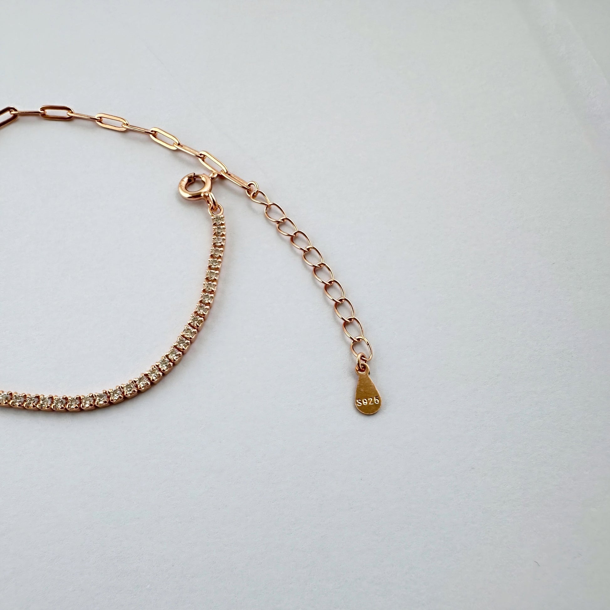 Rose gold bracelet with a diamond tennis chain.