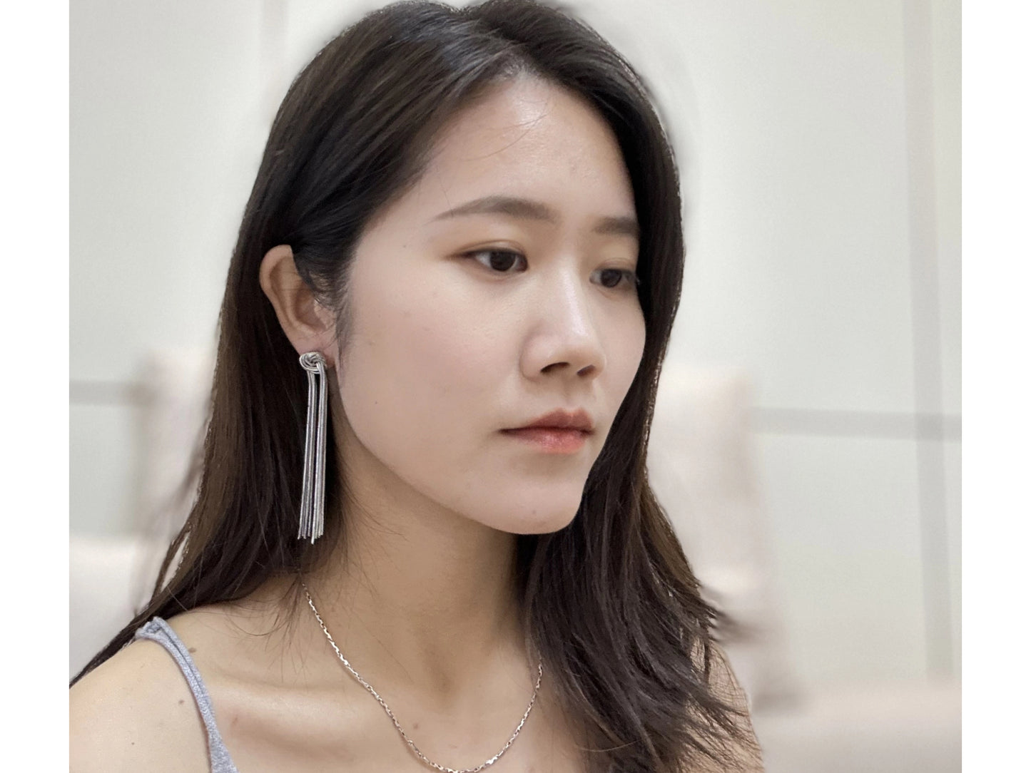 Silver-toned, layered tassel earrings with knotted tops.