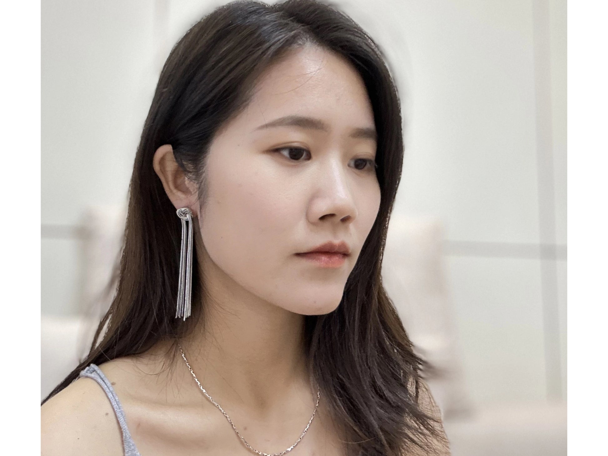 Silver-toned, layered tassel earrings with knotted tops.
