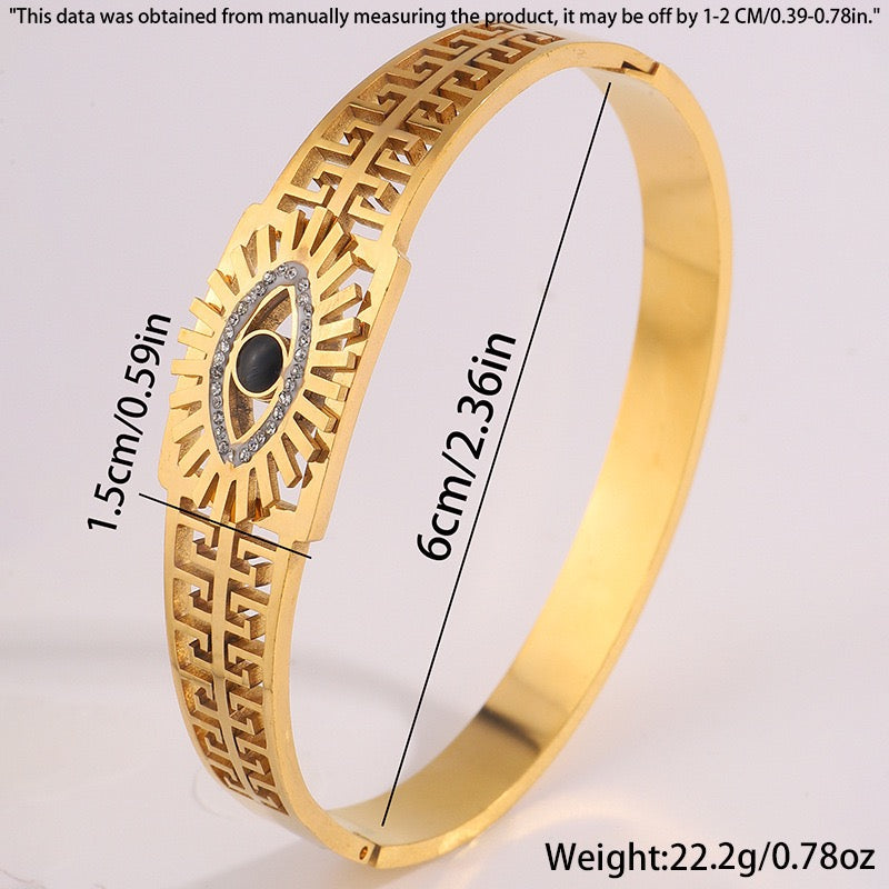 Gold bangle bracelet with a snake design, featuring clear and black crystals, with measurement.